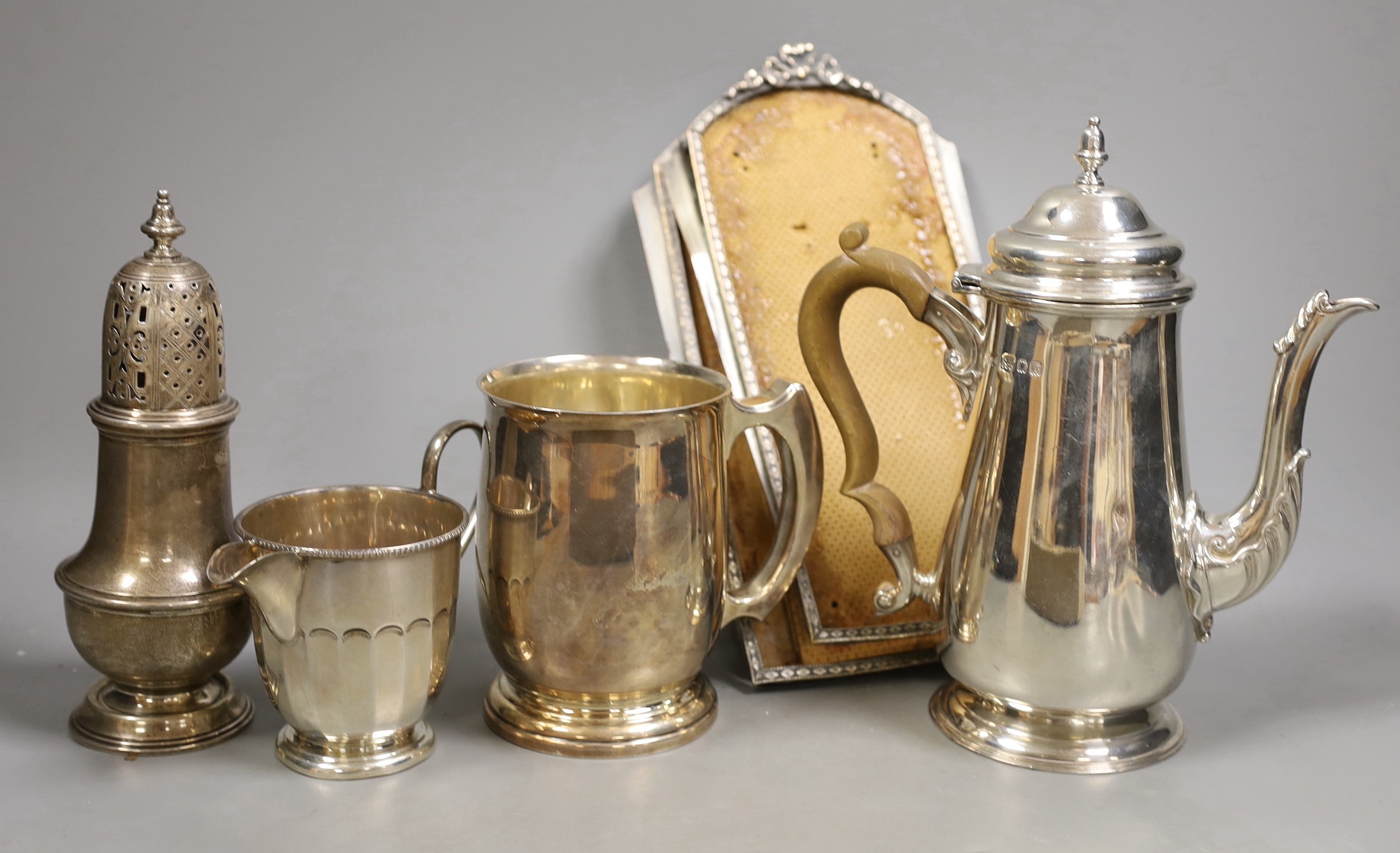 A George V silver coffee pot, London, Carrington & Co 1933, an earlier silver mug by Elkington & Co, a silver sugar caster, cream jug and sugar bowl, a repousse box, pair of silver mounted opera glasses and two plated fr